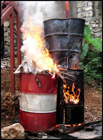 Burning recycled steel drum in Haiti - Haitian metal tropical designs . - www.tropicdecor.com